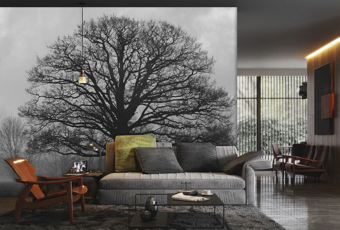 Majestic Black Oak Tree mural in stylish living room with grey sofa, wooden chairs, and modern lighting.