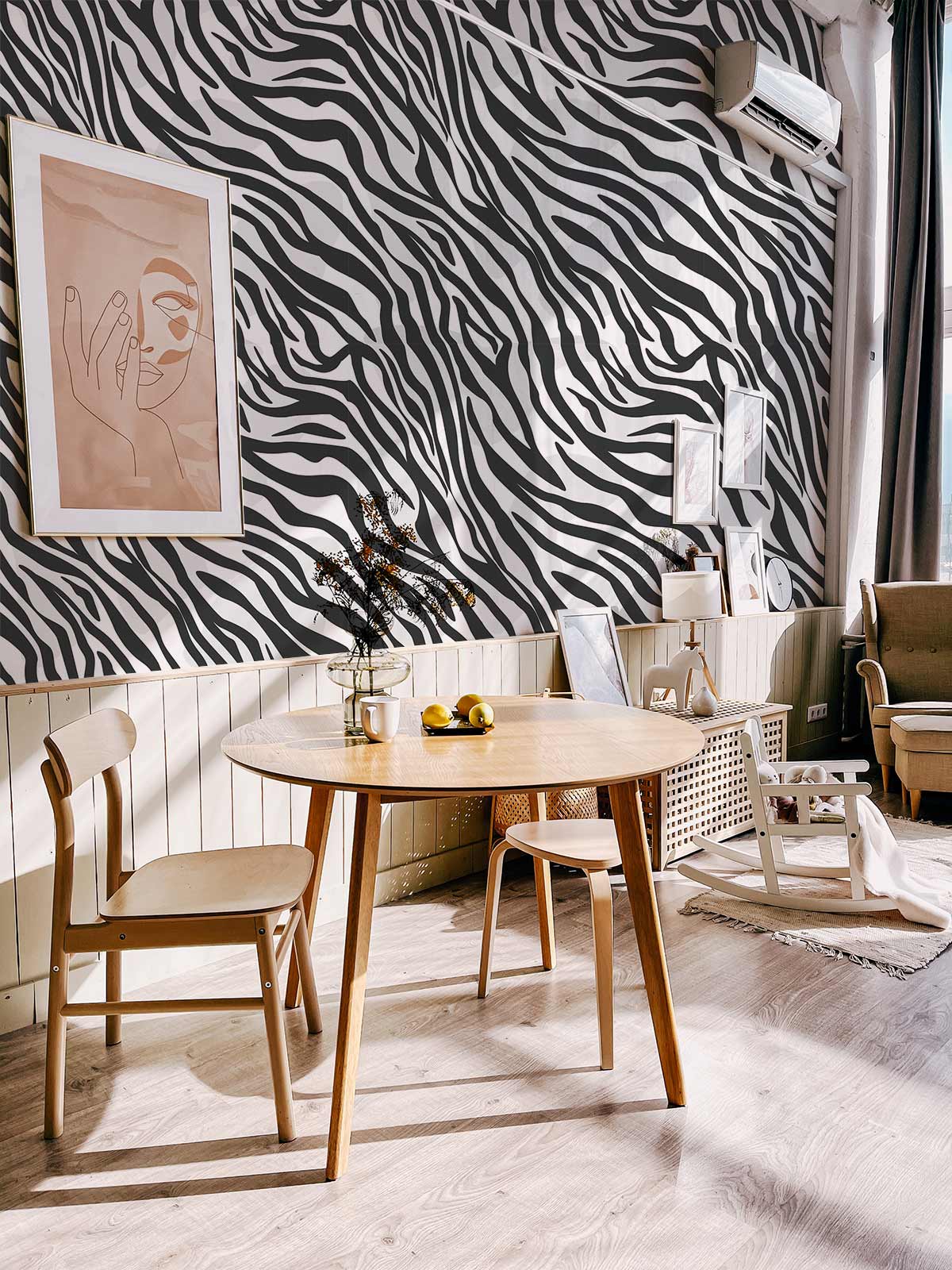 Modern living room with Monochrome Zebra Print Wallpaper, wooden flooring, beige chairs, and artwork on walls.