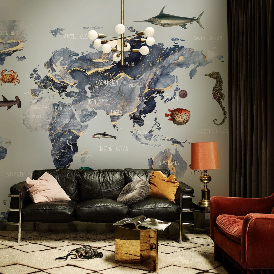 Nautical world map mural decor in living room with dark sofa, gold table, chandelier, and cushions.