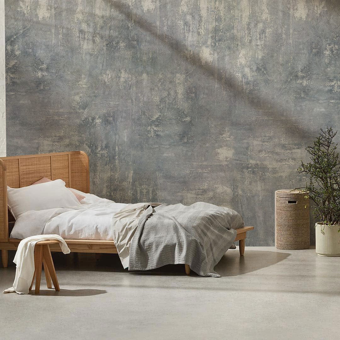 Modern bedroom featuring Icy Blue Mist Textured Abstract Mural Wallpaper, wooden bed, grey flooring.