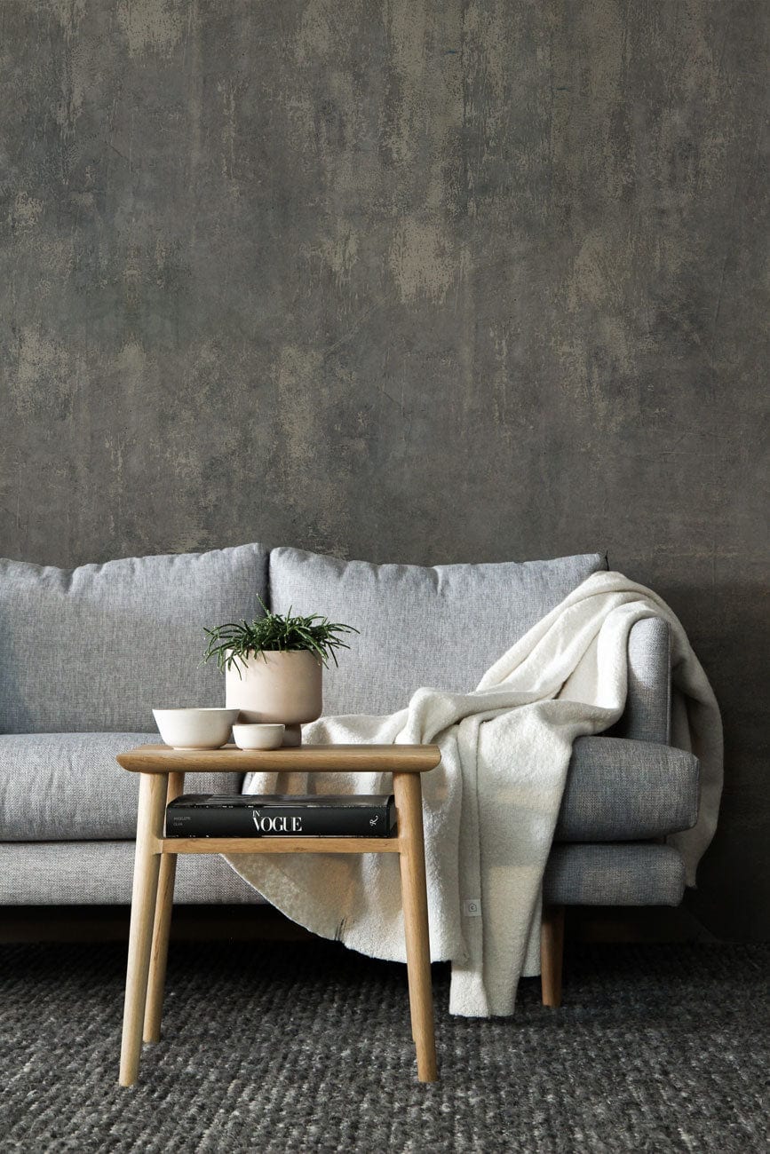 Icy Blue Mist textured mural wallpaper, grey sofa, wooden table, elegant interior living room design.