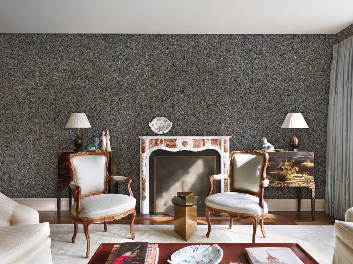 Elegant grey wallpaper in sitting room with vintage chairs, ornate fireplace, and hardwood flooring.
