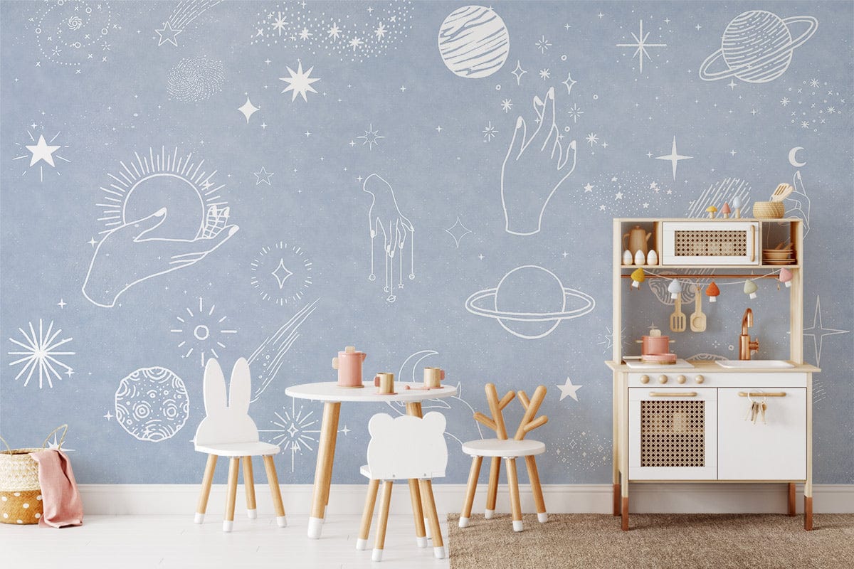 Celestial Dreams wallpaper featuring mystical universe design in children's playroom with wooden table and chairs.