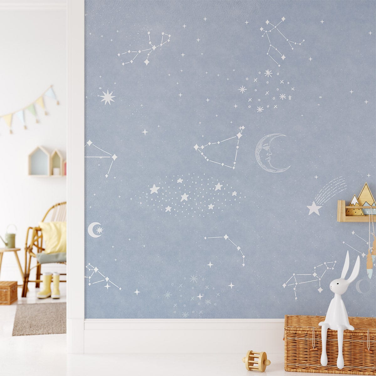 Image of Celestial Dreams Light Blue Constellation Mural Wallpaper, bedroom setting, wicker basket, neutral decor.