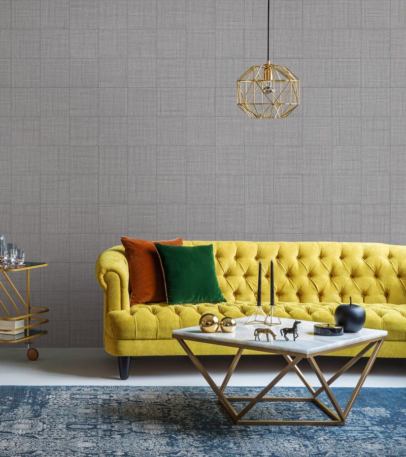 Contemporary grey textured linen wallpaper, yellow tufted sofa, geometric coffee table, modern living room.