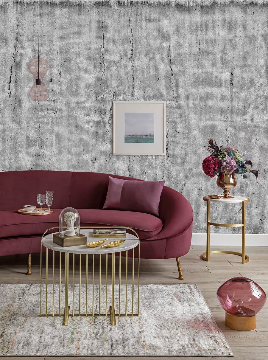 Industrial grey wallpaper, modern urban Décor, mauve sofa, grey rug, gold coffee tables, wooden floor.