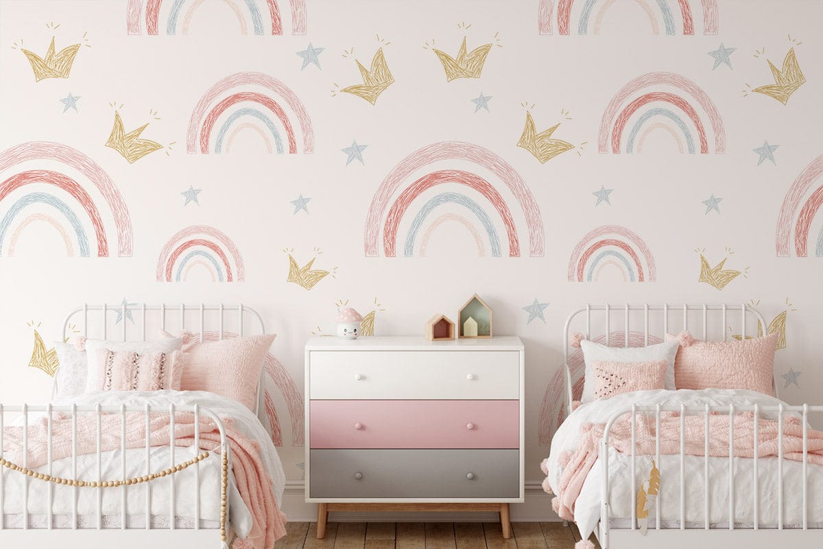 Whimsical pastel rainbow and gold crown kids' room wallpaper with white beds and pink accents.