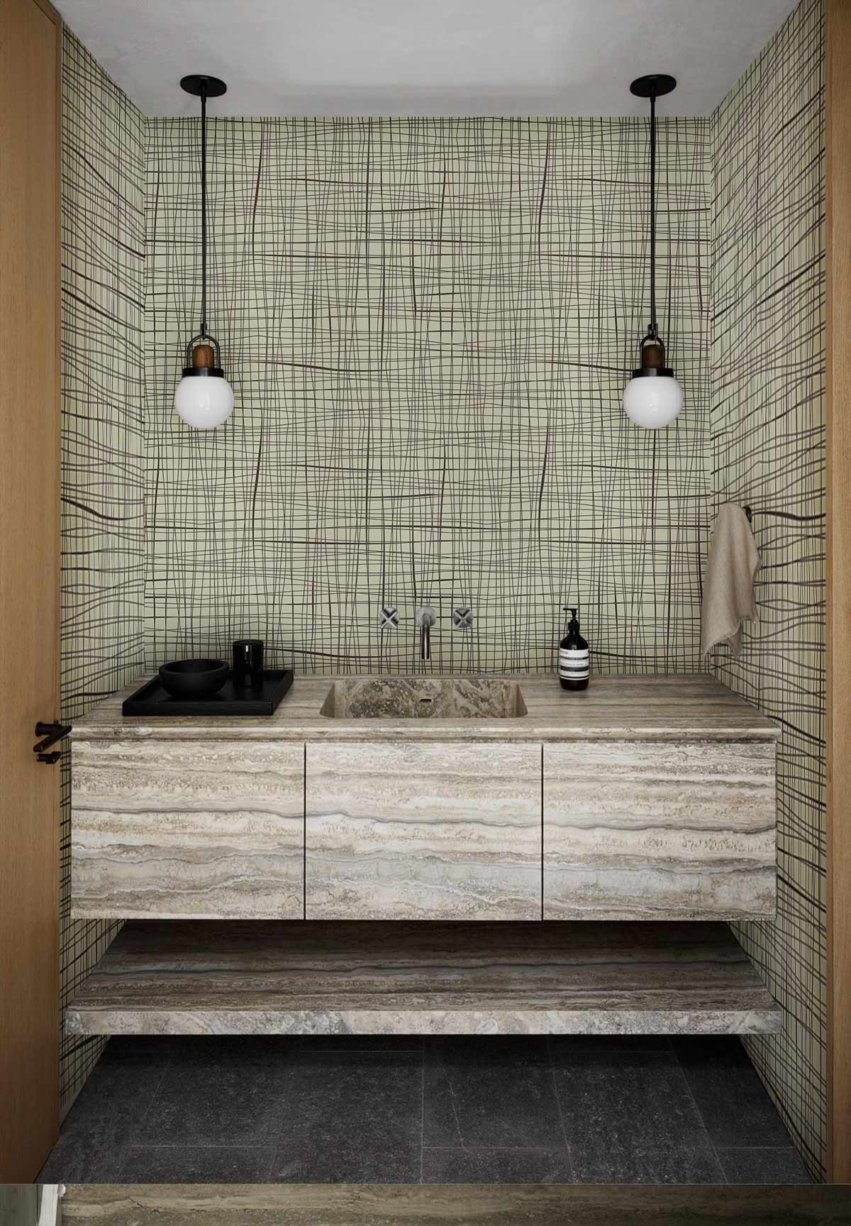 Beige Minimalist Crosshatch Wallpaper in modern bathroom with stone sink, grey flooring, pendant lights.