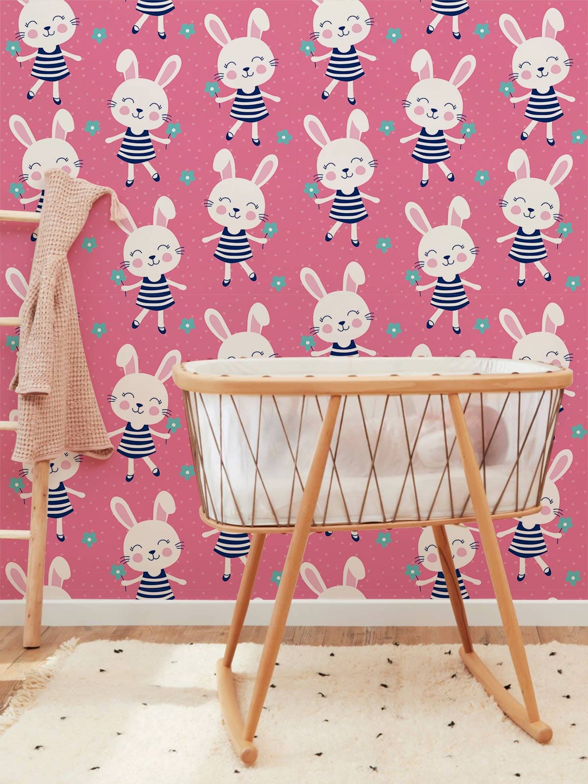 Adorable pink bunny children's wallpaper in nursery with wooden cot and striped pattern accents.