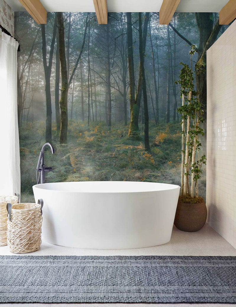 Enchanted Misty Woodland Forest Mural Wallpaper in bathroom, white bathtub, grey flooring, wooden beams.