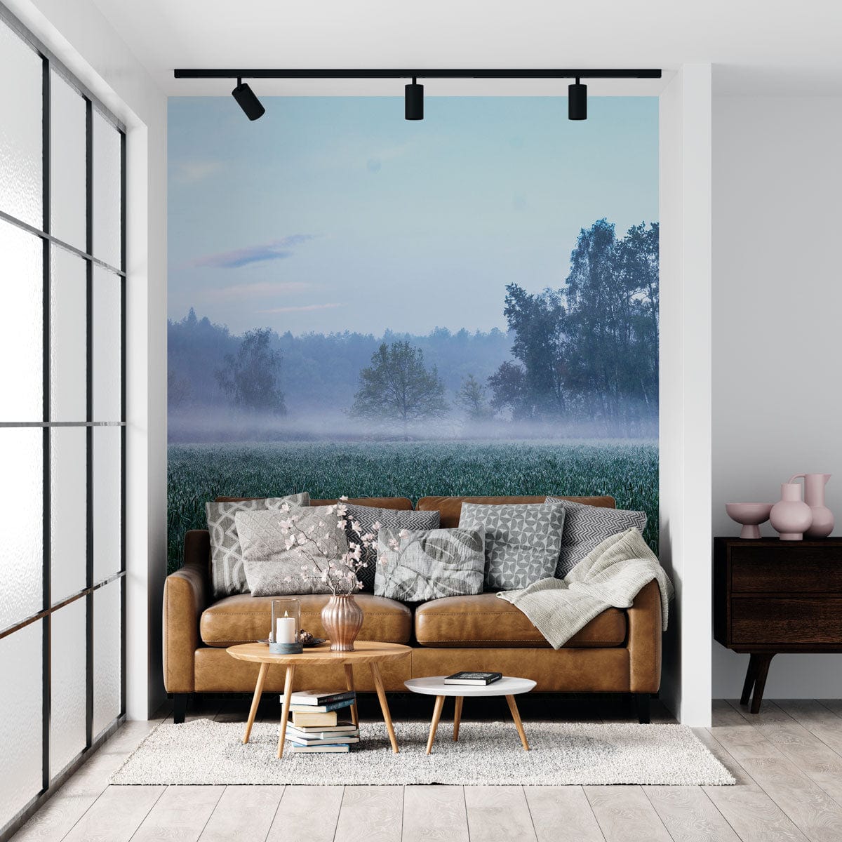 Brown sofa, serene misty forest landscape wallpaper, light grey rug, wooden side table, modern living room.