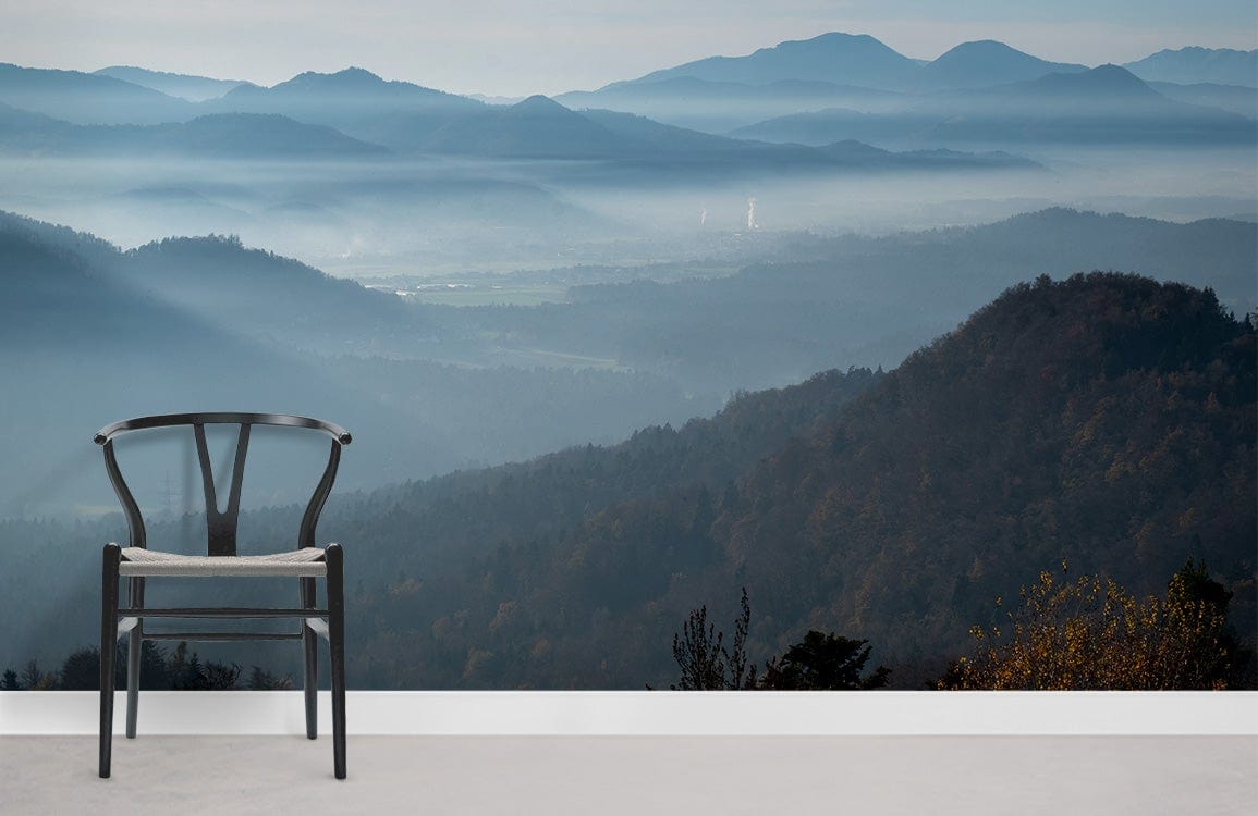 Serene Blue Mountain Mist Landscape Mural Wallpaper, black chair, light grey flooring, tranquil interiors.