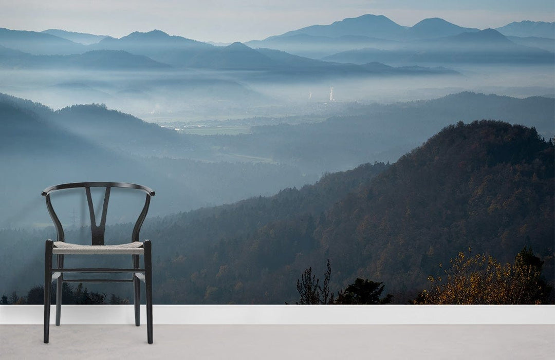 Serene Blue Mountain Mist Landscape Mural Wallpaper, black chair, light grey flooring, tranquil interiors.