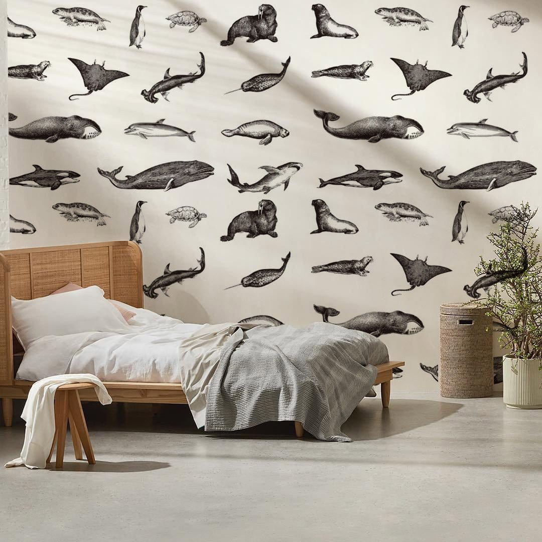 Monochrome wallpaper with marine life pattern, neutral bedroom, wooden bed, grey bedding, minimalist style.