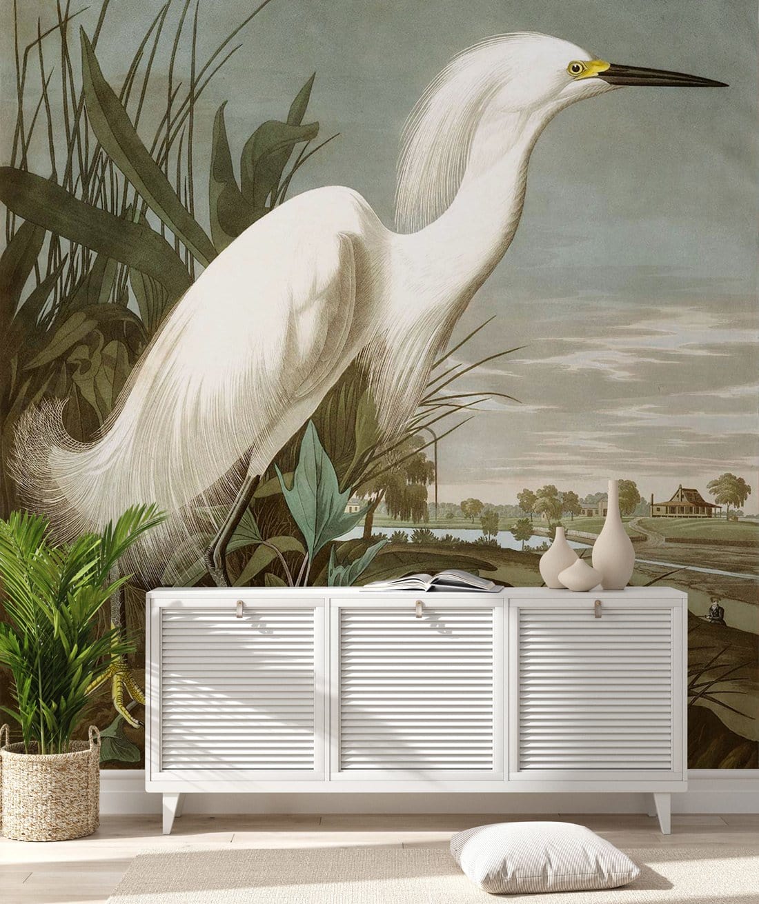 Elegant white egret mural with serene landscape, white sideboard, light wood flooring, decorative vases.