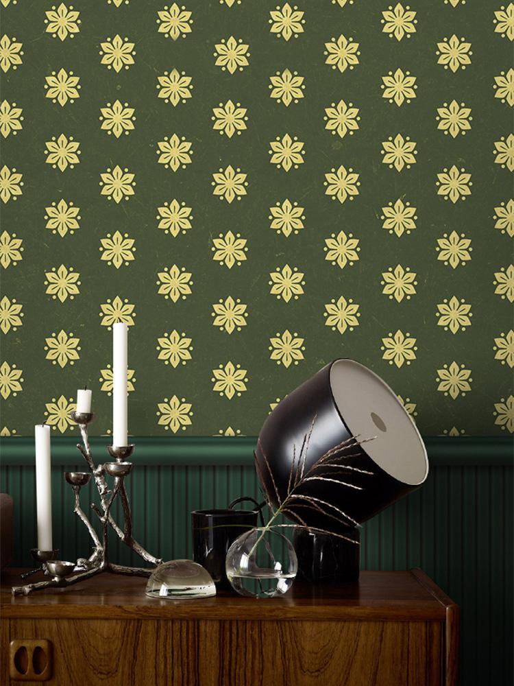 Vintage olive green floral wallpaper in elegant interior with wooden sideboard and modern lamp.