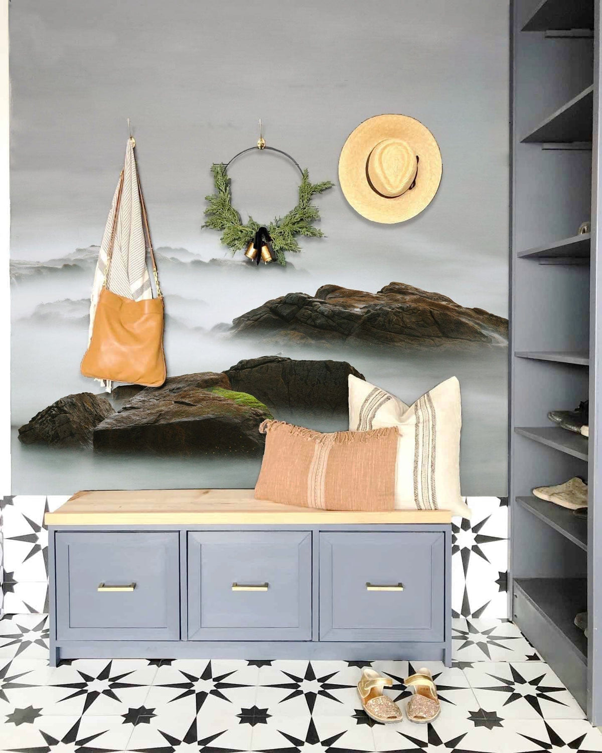Ethereal Coastal Rocks Mural, grey entryway, patterned tiles, blue bench, and tan pillow decor.