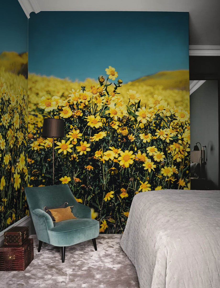 Golden Daisy Field Landscape Mural Wallpaper in bedroom with teal chair, grey rug, elegant decor.