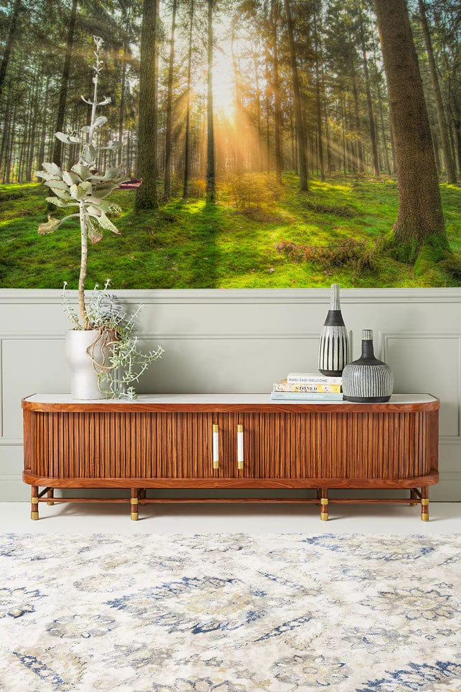 Forest Serenity Sunlit Green Woodland Mural Wallpaper in living room with wooden sideboard and area rug.