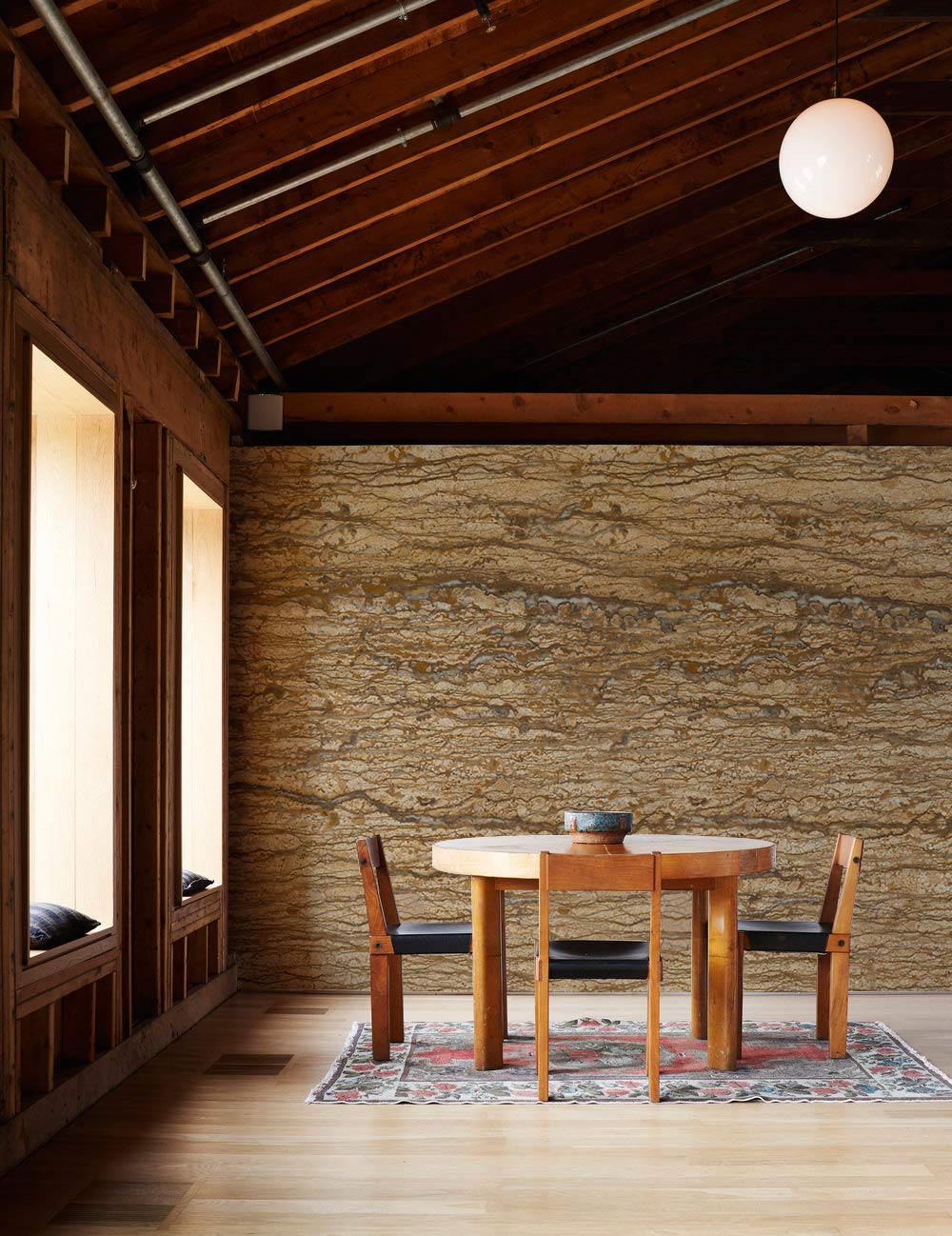 Rustic Earth Tones wall mural with wooden dining set, textured stone effect, and wooden flooring.