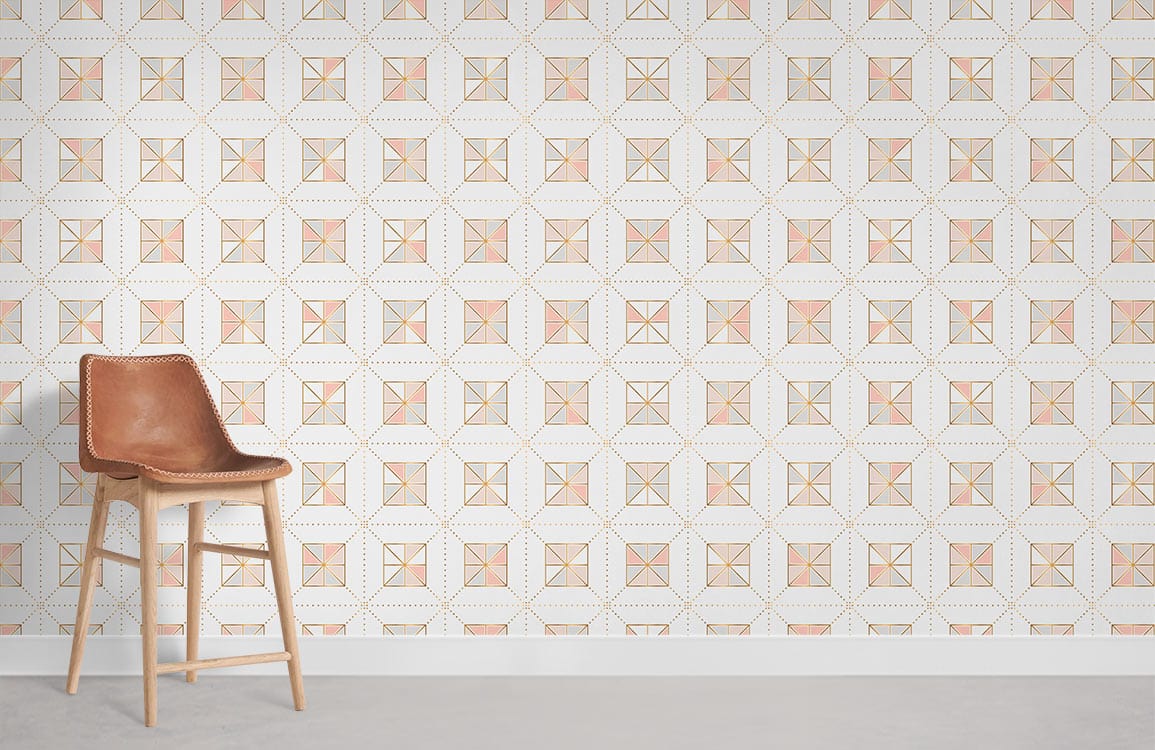 Geometric soft pink and gold wallpaper with brown leather chair on grey flooring for modern interiors.