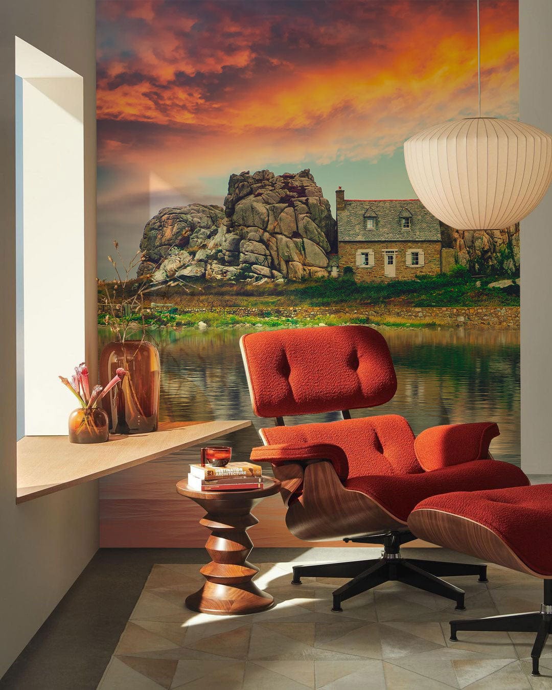 Rustic Coastal Sunset Mural Wallpaper, red Eames chair, beige geometric flooring, pendant lamp in stylish room.