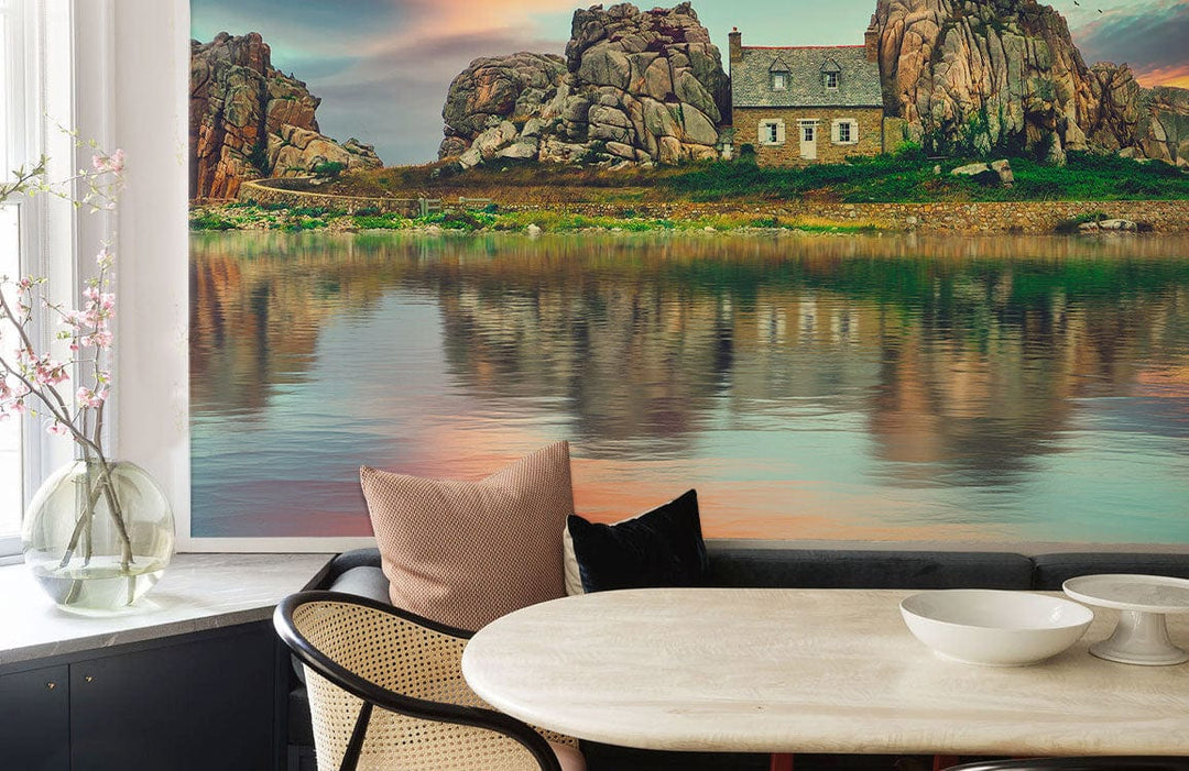 Rustic Coastal Sunset Mural Wallpaper with tranquil waters, rocky cliffs; stylish dining room setting.