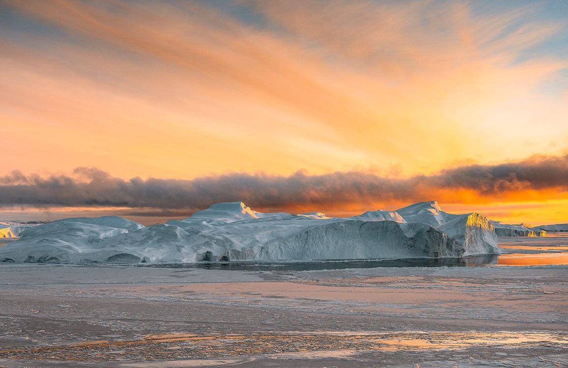 Sunset Arctic Ice Landscape Mural Wallpaper in Warm Orange Tones