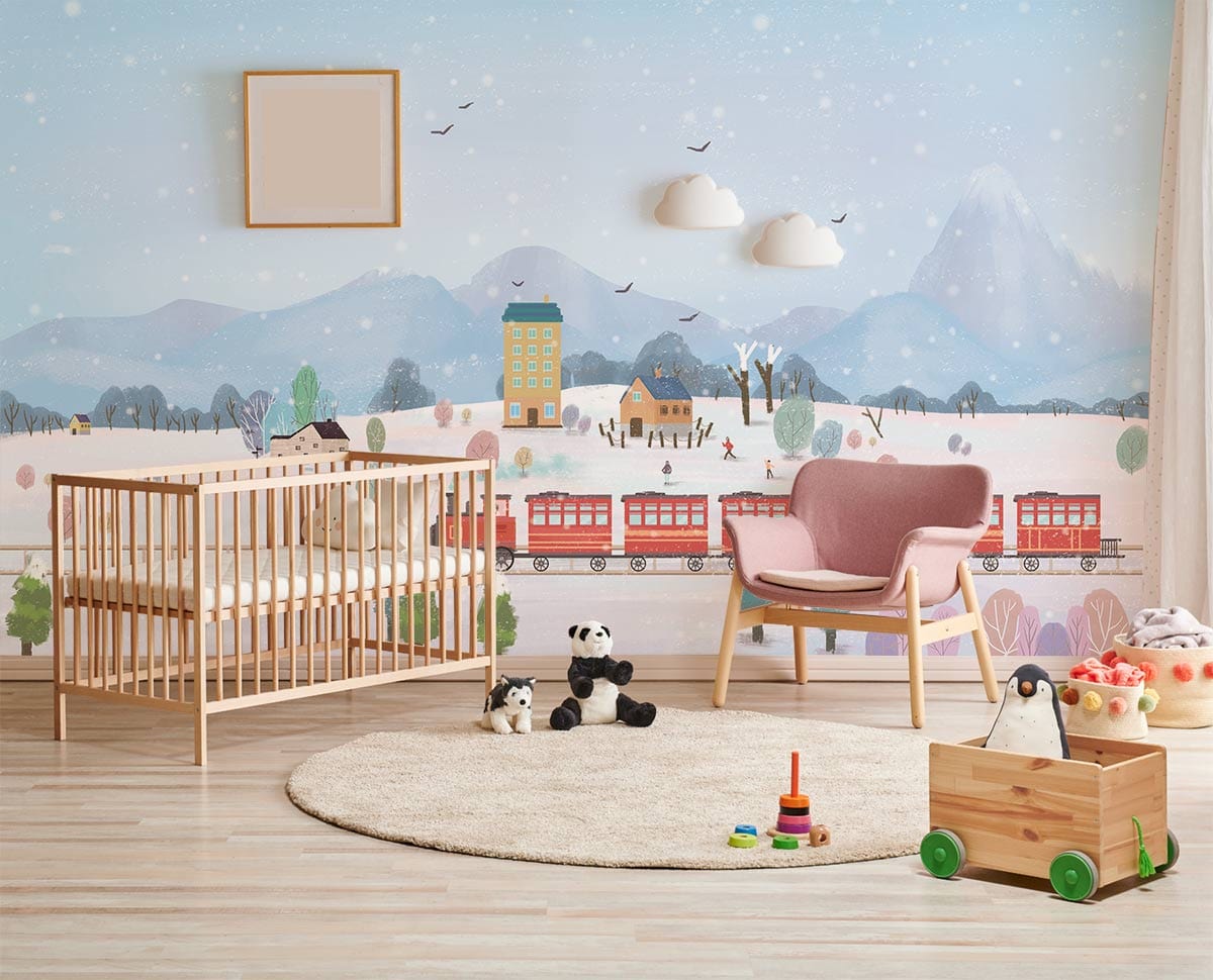 Whimsical Winter Wonderland mural in nursery with wooden cot, pastel armchair, light wood flooring.