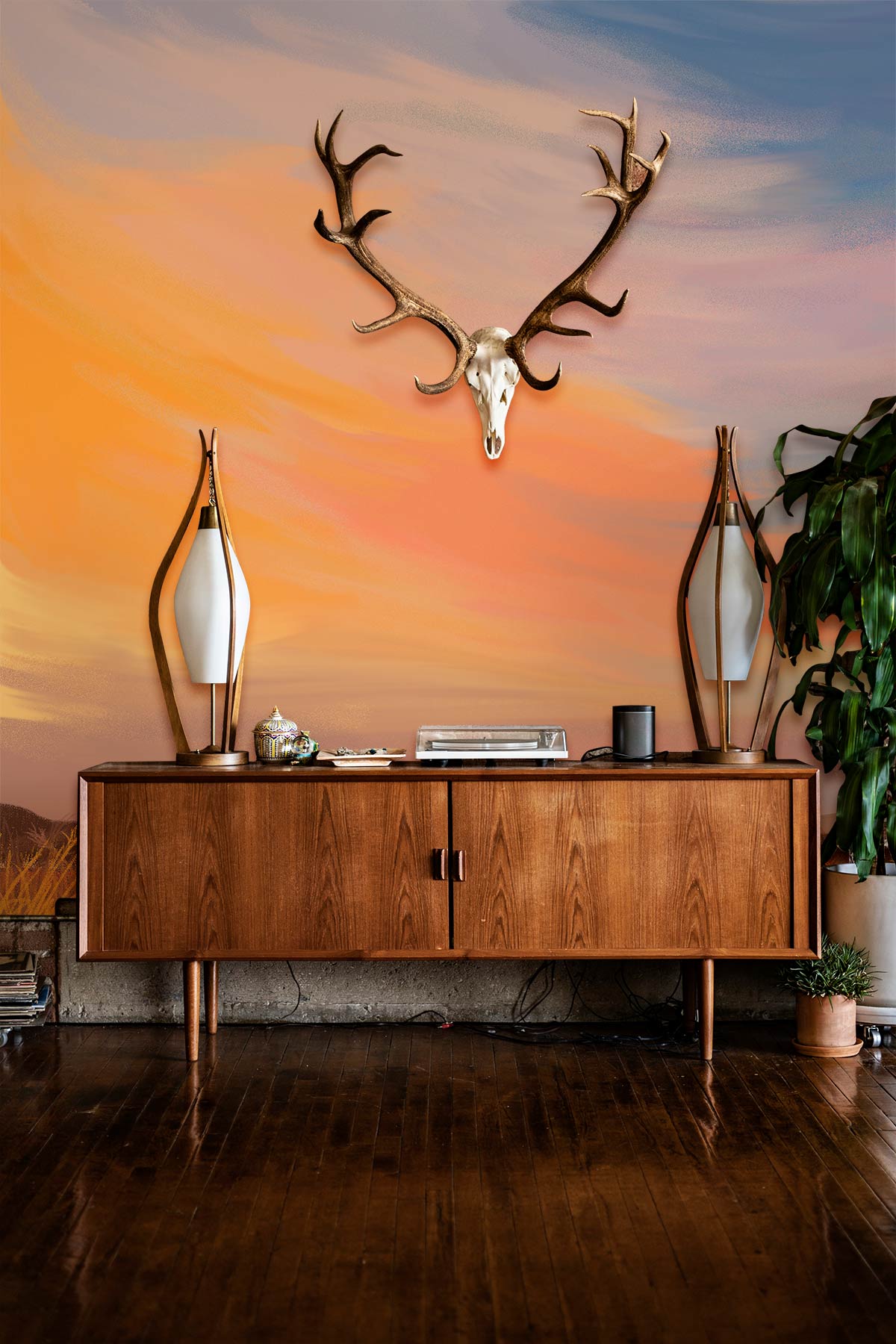 Tranquil Sunset Mural with Mid-Century Sideboard on Hardwood Floor, Antlers Decor, Warm Pastel Palette.
