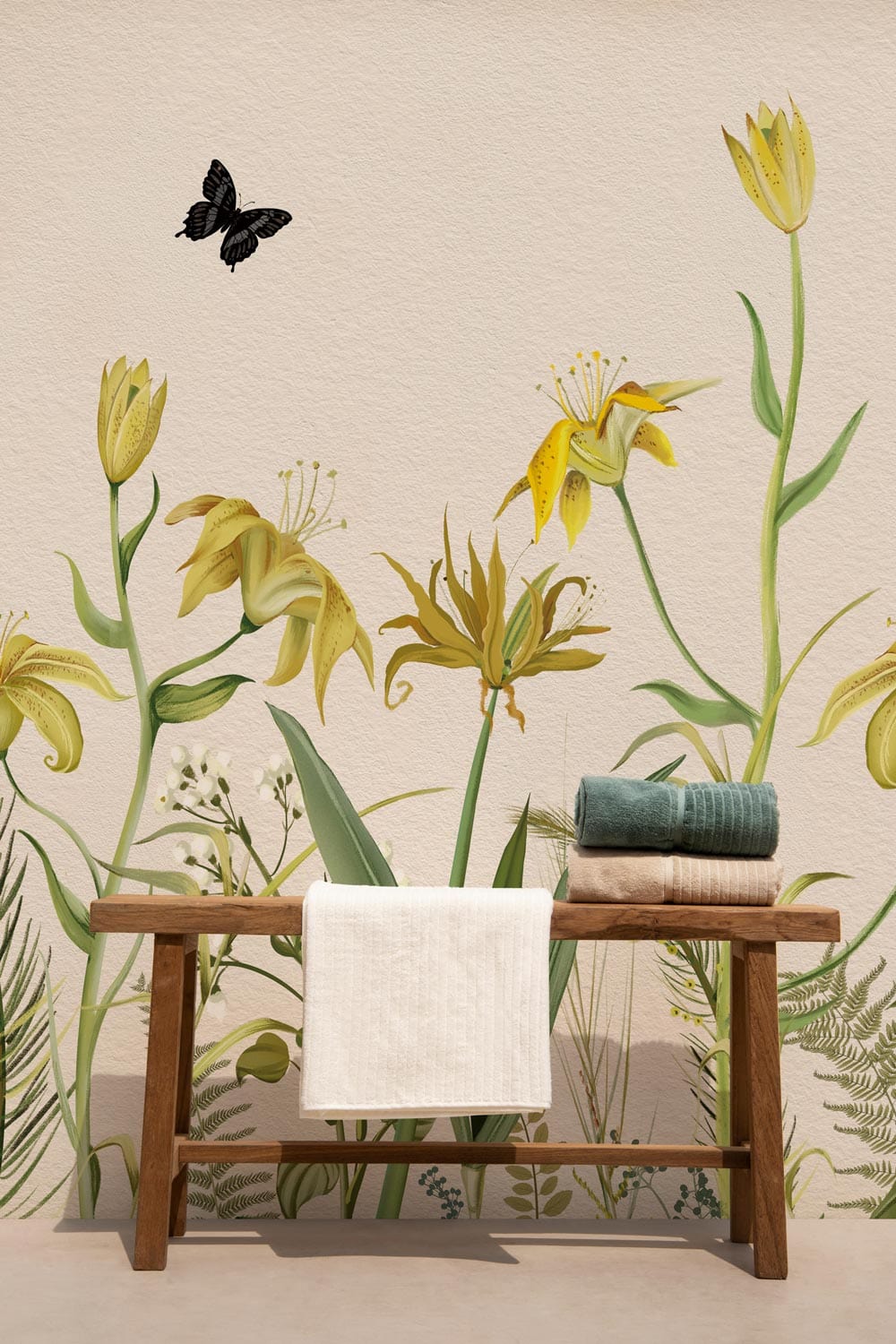 Vintage Botanical Floral Garden Mural Wallpaper in Soft Yellow and Green with wooden bench and towels.