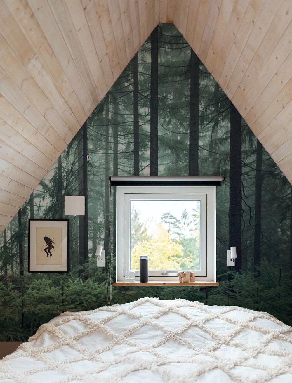 Enchanted Forest Mural Wallpaper in attic bedroom with wooden ceiling, neutral bedspread, and window view.