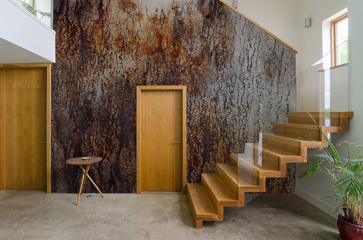 Rustic Textured Abstract Wallpaper in earthy tones, modern interior with wooden stairs and doors.