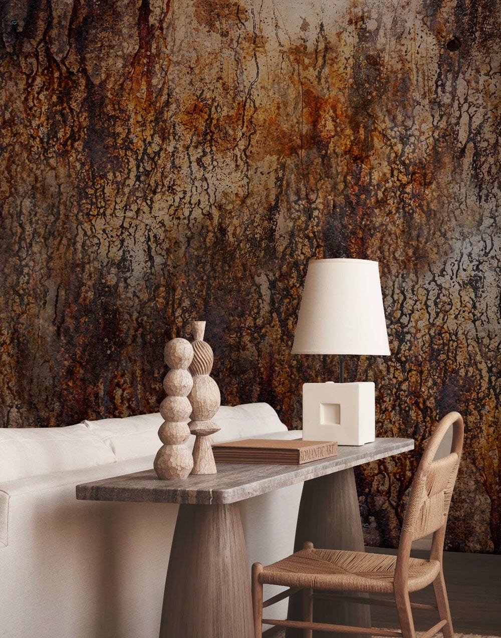 Rustic textured abstract wallpaper with earthy tones, beige sofa, wooden table, chair, and lamp.
