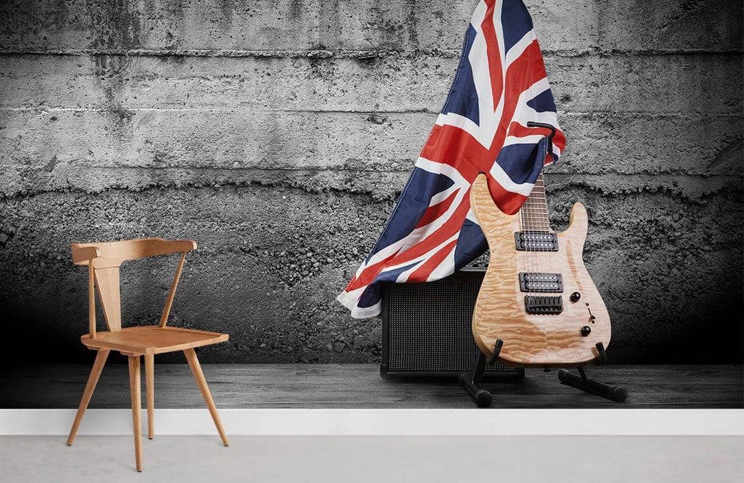 Vintage Union Jack Guitar Mural on Grey Concrete Wall with Wooden Chair on Light Floor.