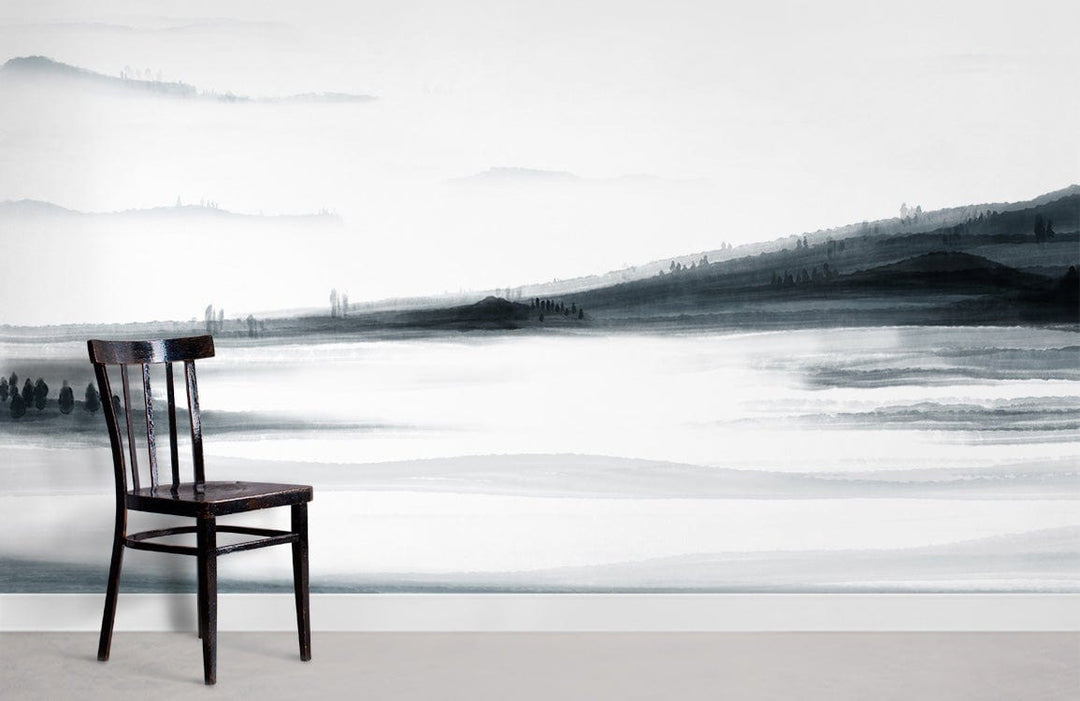 Monochrome misty landscape mural wallpaper with black chair; serene black and white design on wall.