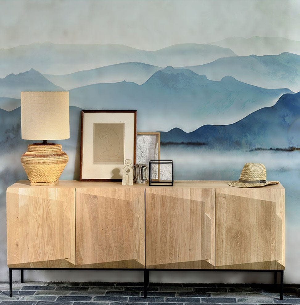 Tranquil Blue Misty Mountain Landscape Mural, light wood sideboard, stone tile flooring, calming room.