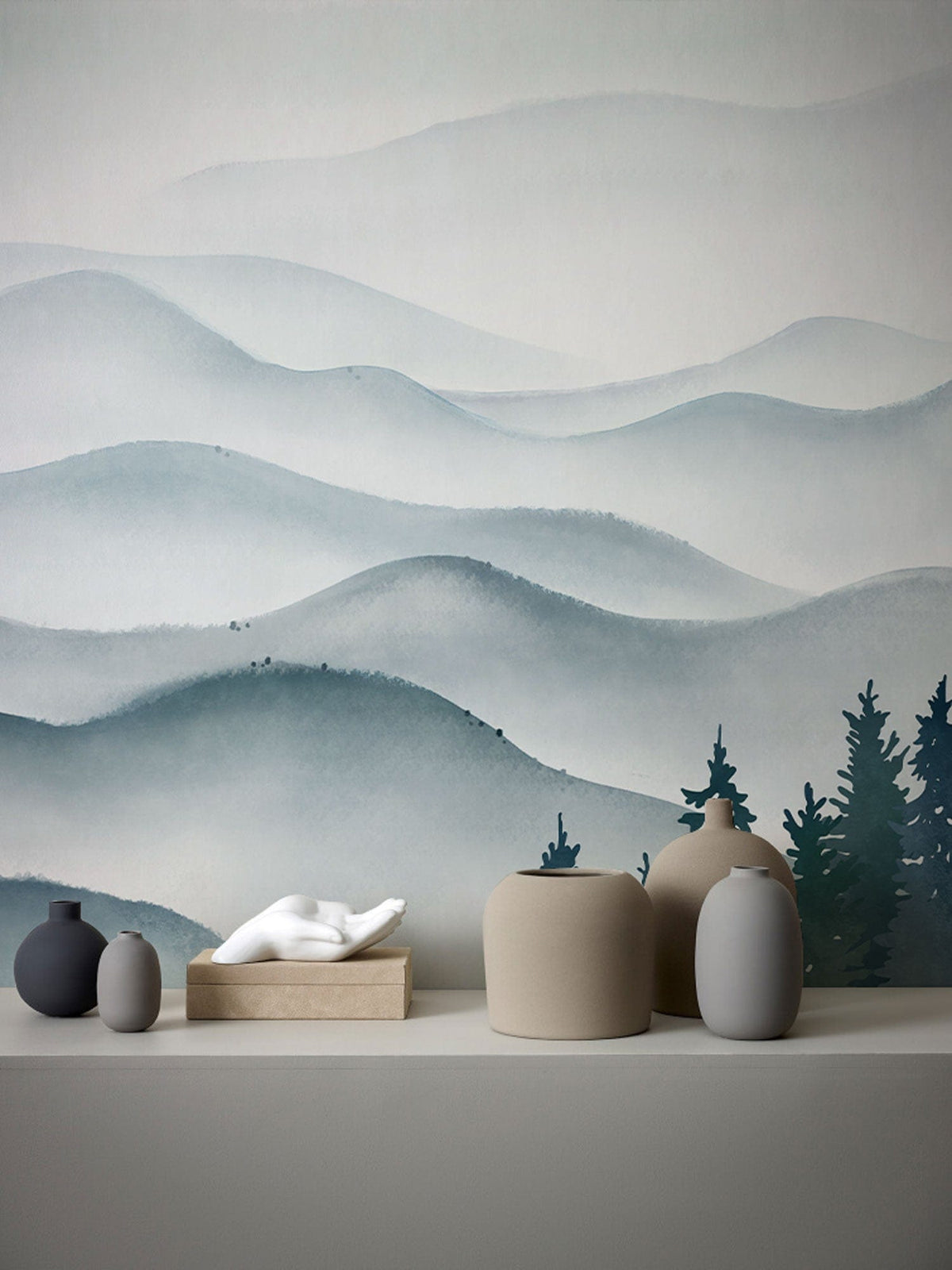 Serene Misty Mountains wallpaper in calming blue hues, modern minimalistic decor with ceramic vases.