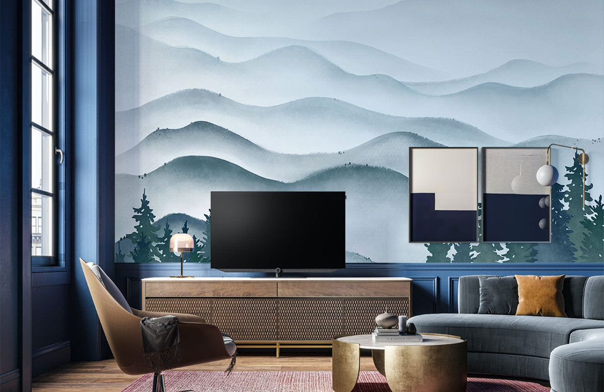 Misty mountain wallpaper, blue themed lounge, grey sectional sofa, wooden flooring, modern decor accents.
