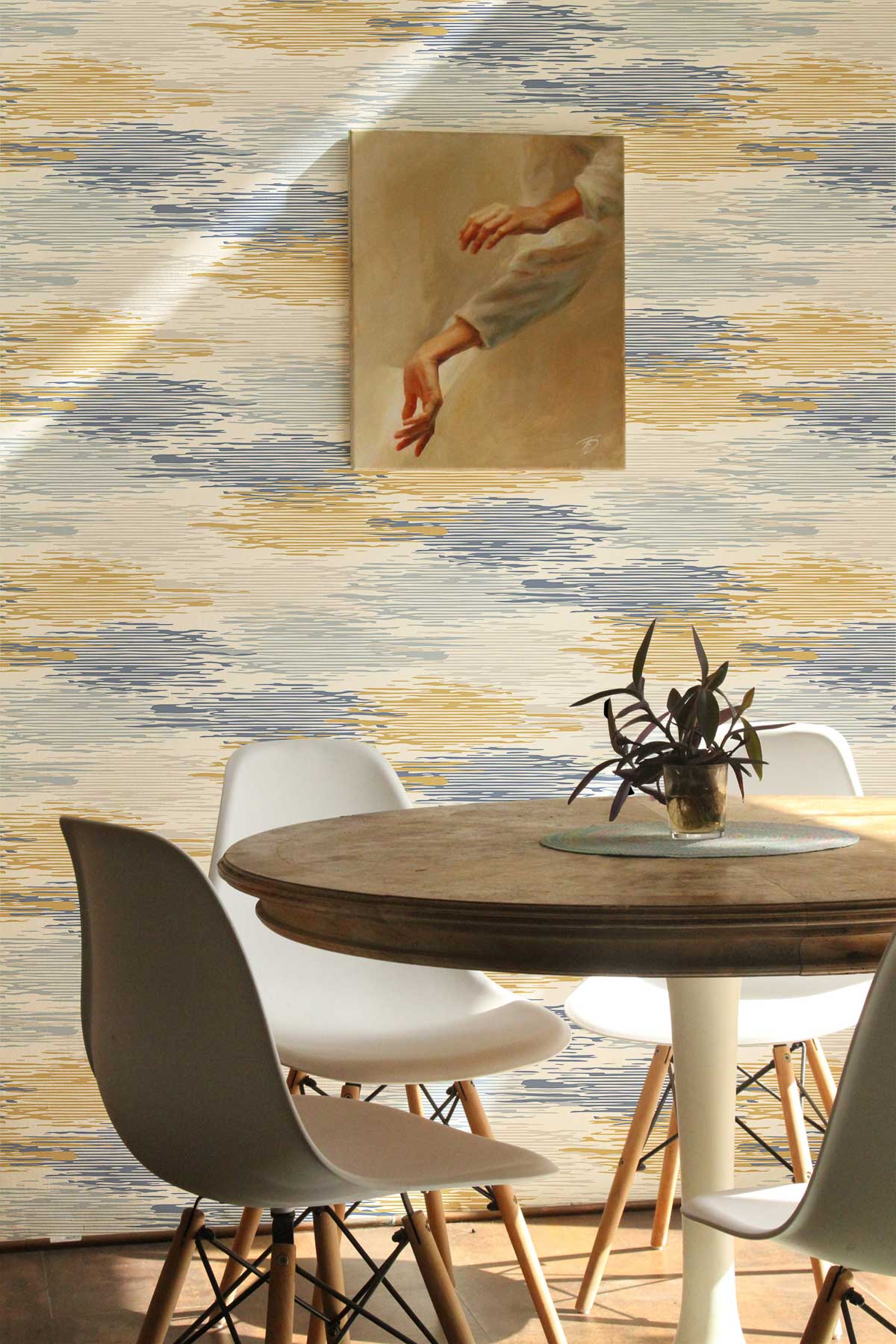 Elegant blue and gold watercolour wallpaper in dining room with modern white chairs and wooden table.