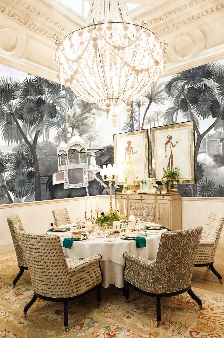 Exotic Jungle Safari Mural with elephants, palm trees; elegant dining room featuring ornate chandelier and chairs.