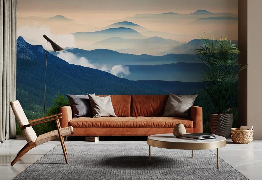 Rustic sofa, modern armchair, grey rug, floor lamp, Tranquil Misty Mountain Mural Wallpaper, serene living room.