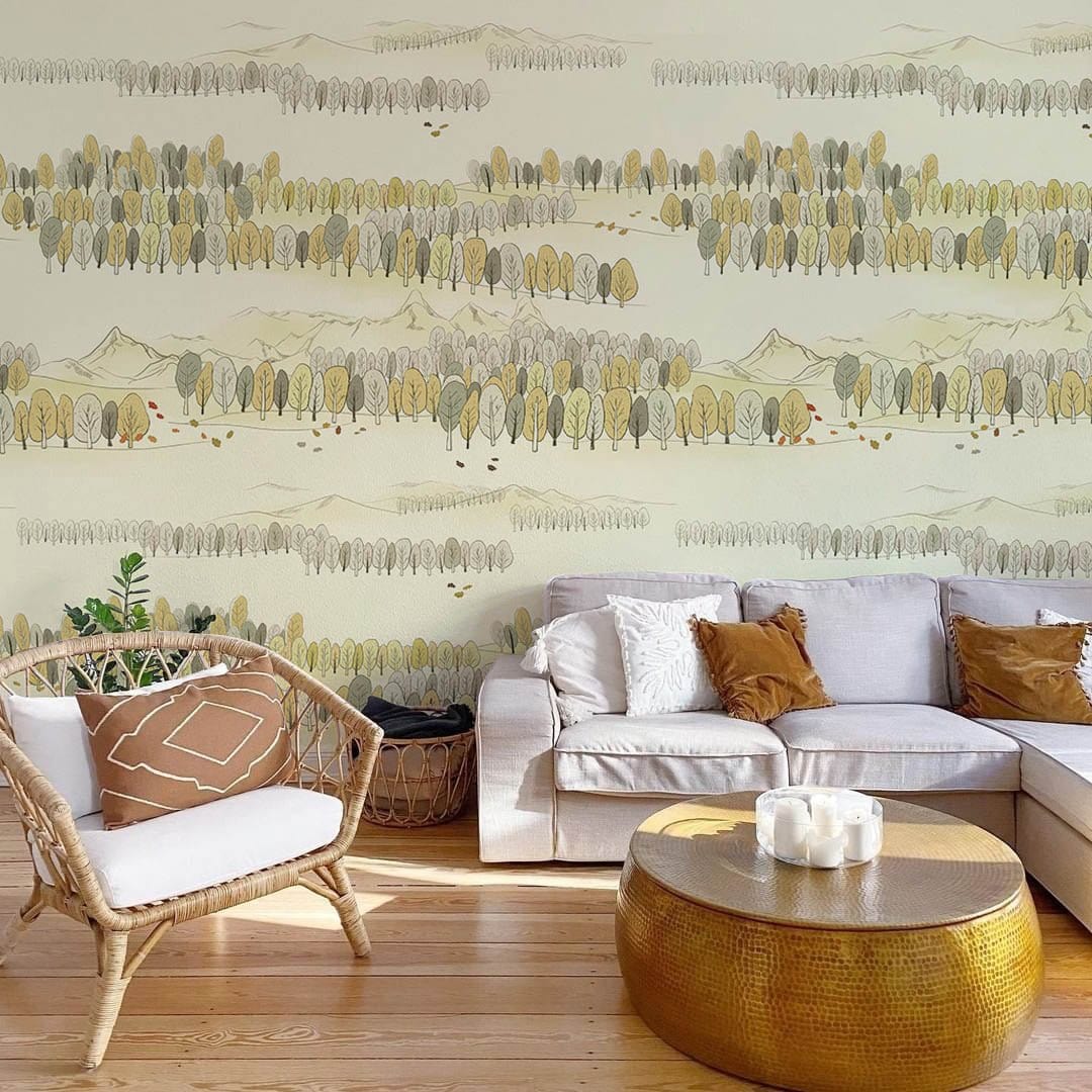 Serene Autumn Forest Landscape mural wallpaper in living room with white sofa, rattan chair, wooden flooring.