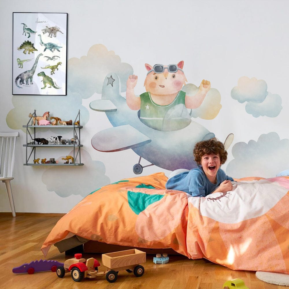 Whimsical Aviator Bear Mural Wallpaper in children's bedroom with warm wooden flooring and playful decor.