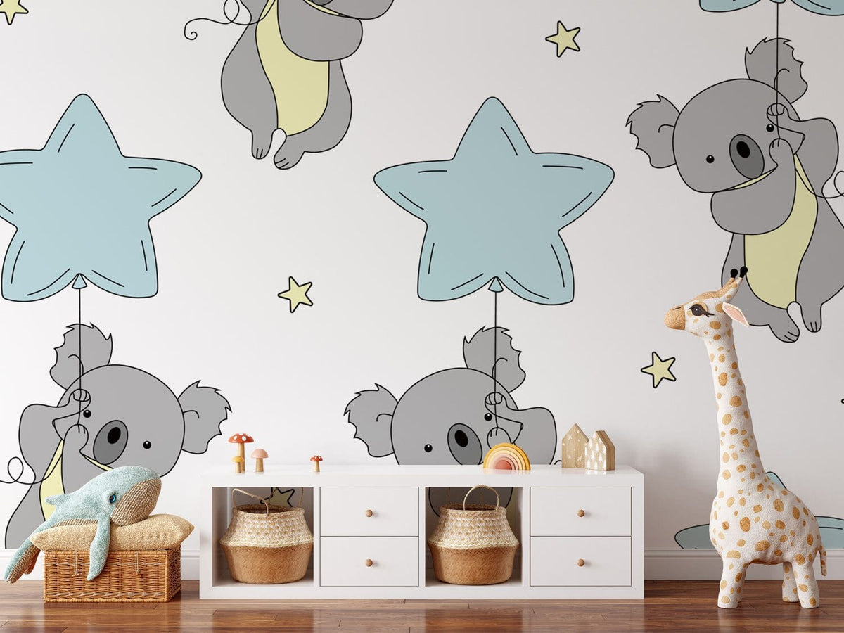 Children's nursery with Grey Koala and Blue Star Wallpaper, white dresser, and wooden flooring.
