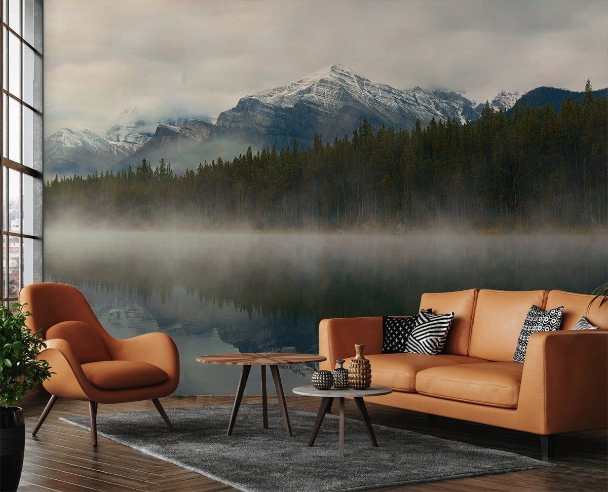 Misty mountain lake mural wallpaper in living room with brown leather sofa, armchair, wooden flooring.