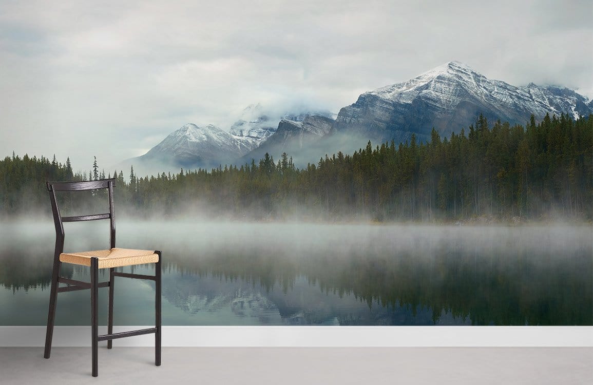 Tranquil green nature mural wallpaper with chair, misty lake, and mountains in serene room setting.