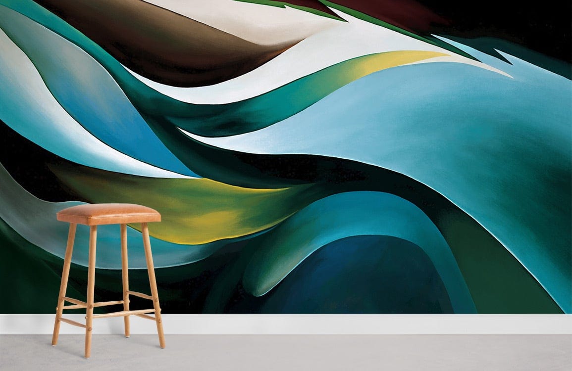 Elegant abstract waves mural wallpaper in teal green, earth tones, with stylish wooden stool on grey flooring.