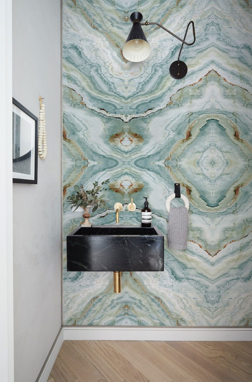 Elegant Teal Marble Effect Wallpaper Mural in bathroom with black sink, wooden floor, and wall lamp.
