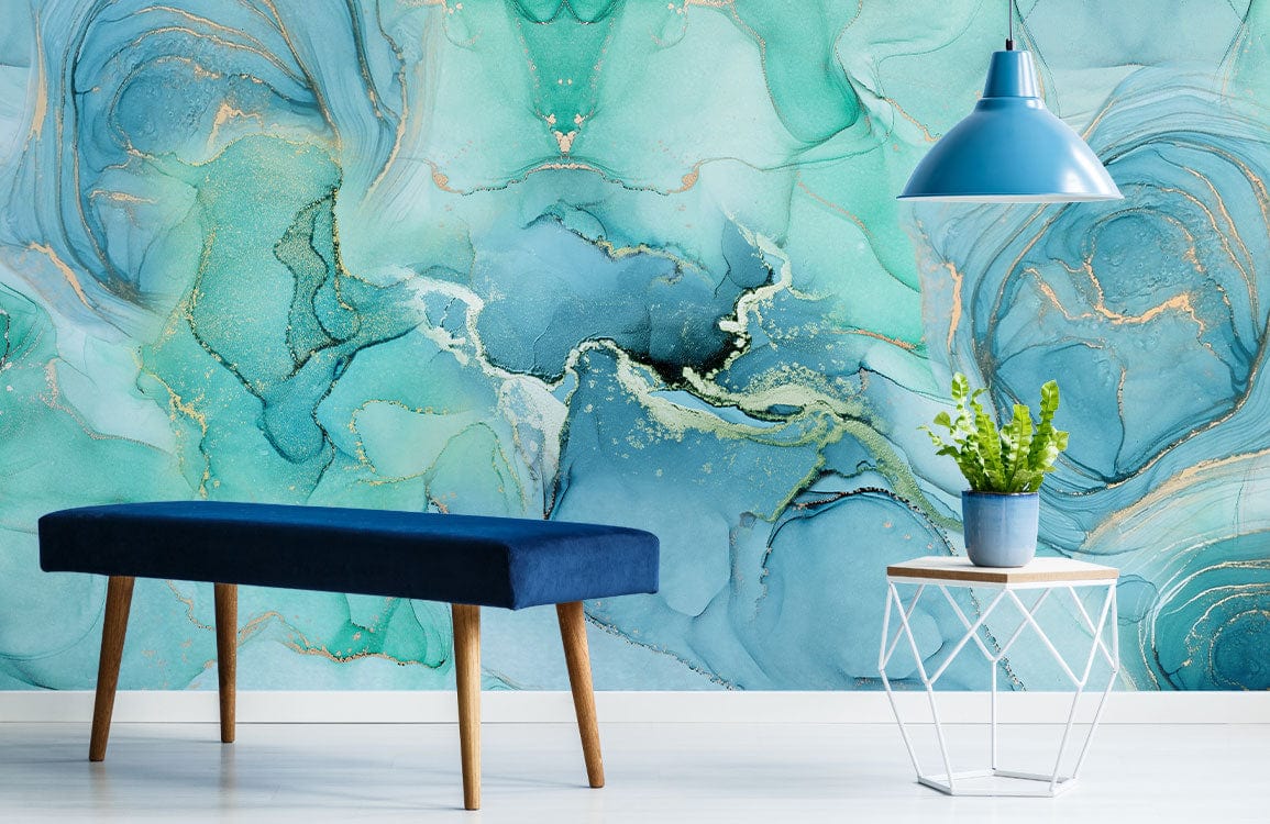 Turquoise watercolour mural with gold accents, blue bench, pendant lamp, light flooring, modern room decor.